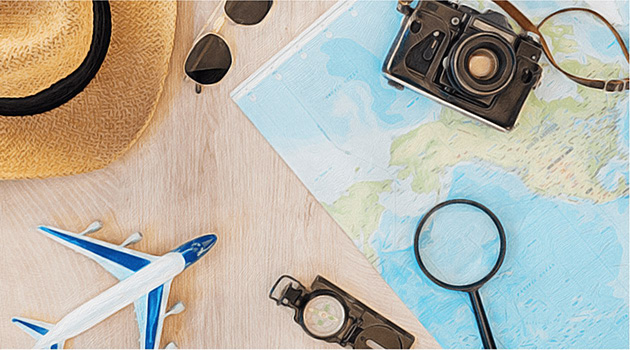 Map, old-fashioned camera, hat, compass, and small toy plane